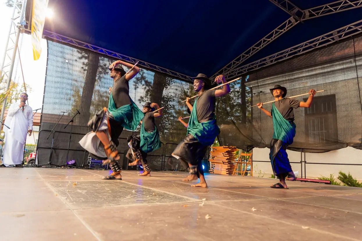 Dancers on stage in purple lighting